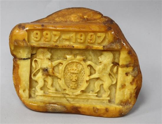 A piece of raw amber carved with the crest of the Polish City of Gdansk with the date 997-1997.